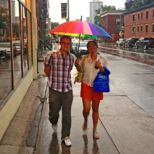 Glen and Pauline sheltering under a rainbow during the rain.