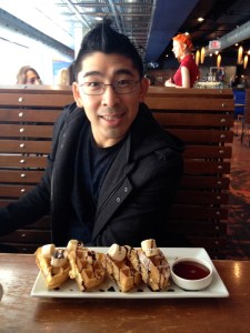 Albert at breakfast - waffles with syrup, chocolate and bananas.