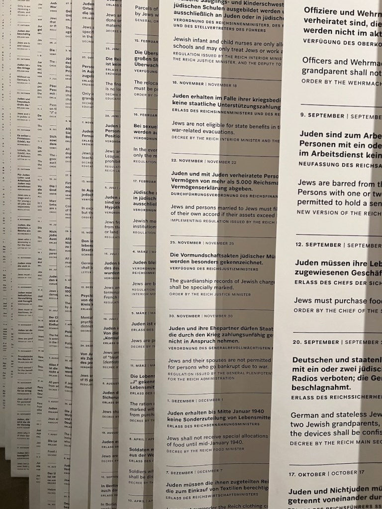 Rows of printed pages containing regulations and decrees related to Jewish restrictions and policies during the Nazi regime, with dates and formal headings in German.